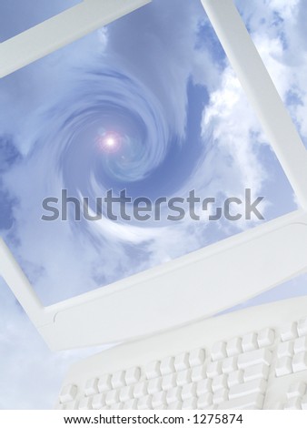 Pc monitor and keyboard with swirling clouds and light effect.