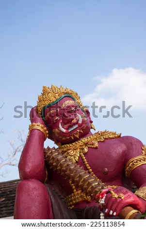 Red guardian statue at the Temple of Thailand