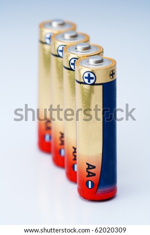 Closeup photo on small battery with positive and negative signs.