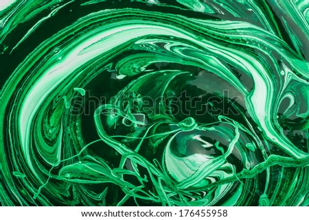 Green dye in white acrylic paint mixing process