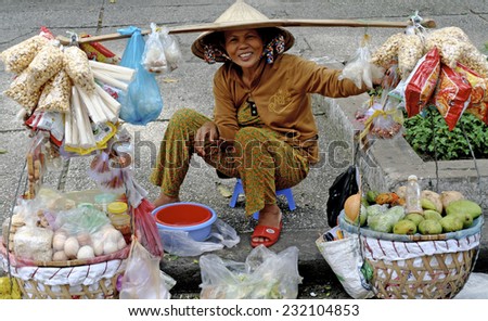 HO CHI MINH, VIETNAM-NOVEMBER 10: A Vietnamese lady sells various items along the sidewalk in Ho Chi Minh on December 7, 2010 in Ho Chi Minh, Vietnam..Ho Chi Minh is the largest City in Vietnam.