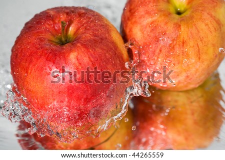 Apple of red color in a stream of water