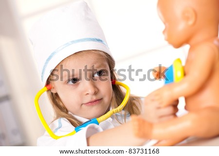 girl playing with dolls in the hospital