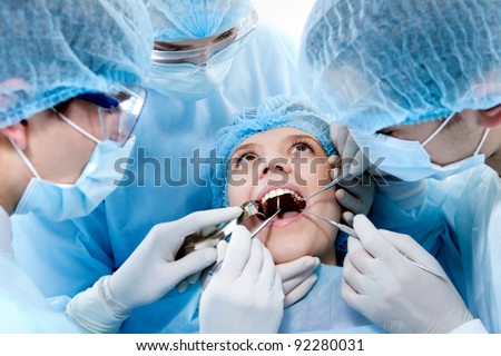 young dentists operate on a tooth