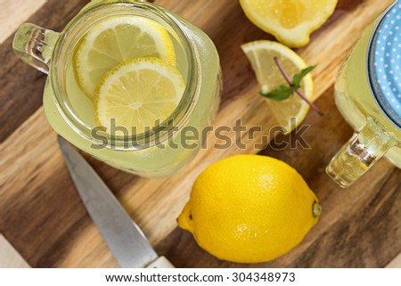 2 lemonade in jars with ice and mint from top view.