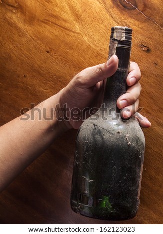 Alcoholic, old bottle in hand.