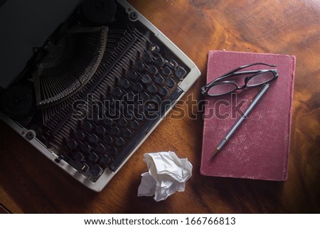 Old typewriter with book,pen and eyeglasses