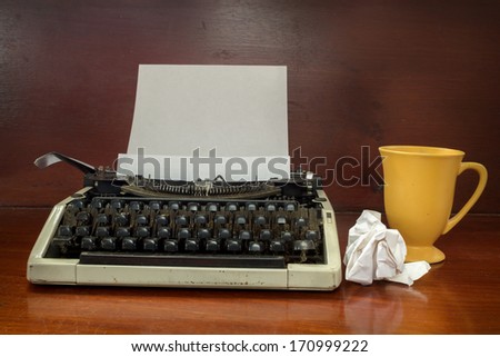 Typewriter with coffee cup.