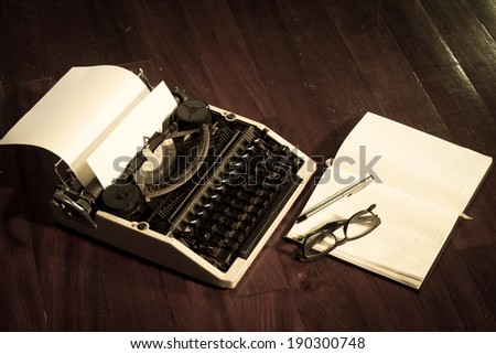 Typewriter with book and eyeglasses,vintage color.