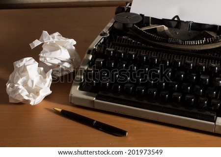 Old style office table,Typewriter with paper and pen,