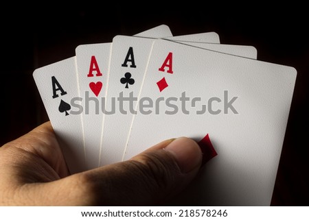 Four Aces cards in hand for play gamble.