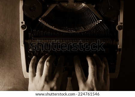 Human hands typing with typewriter,black and white color.