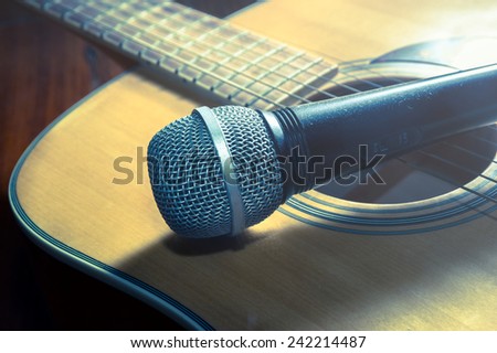 Microphone on acoustic guitar,vintage filtered.