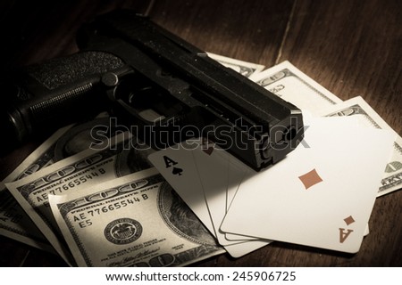 Sepia filtered color Card with money and gun.