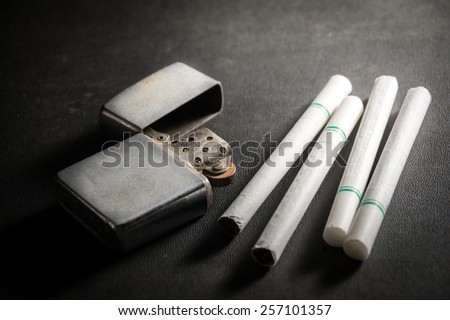 Cigarettes with old metal lighter.