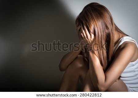 Sad girl sitting and crying,social problem.