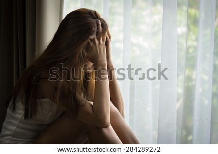 Sad girl sitting and crying,social problem.