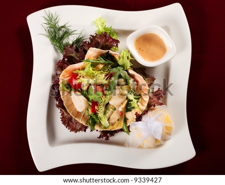Seafood salad with vegetable on white square plate
