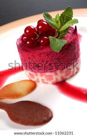 Dessert cake with red fruit isolated on black background