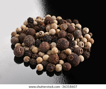 Peper mix spice round heap closeup on black white background