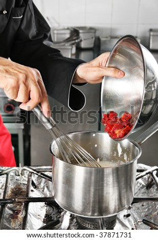 Chef add strawberry in pan with milk