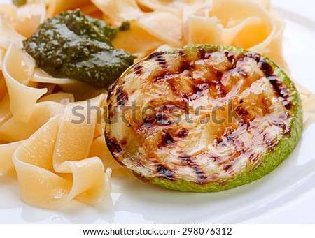Closeup grilled zuccini round with noodles