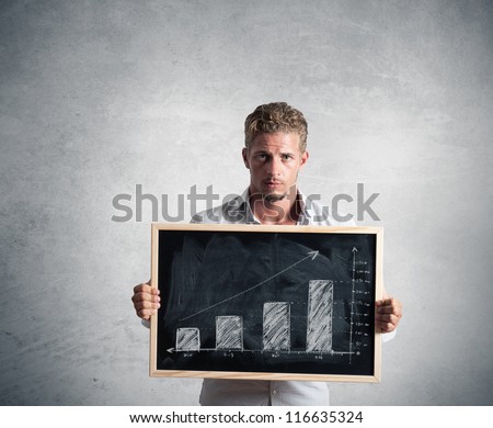 Businessman show positive trend in a blackboard
