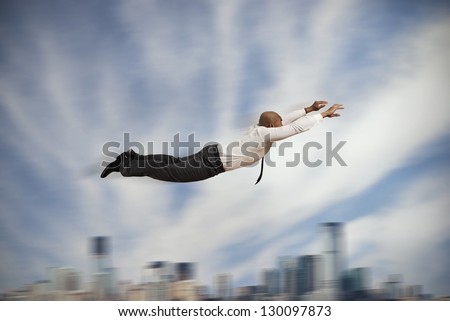 Flying super hero businessman concept of power in business