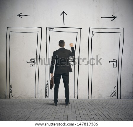 Businessman opens a door designed in a wall