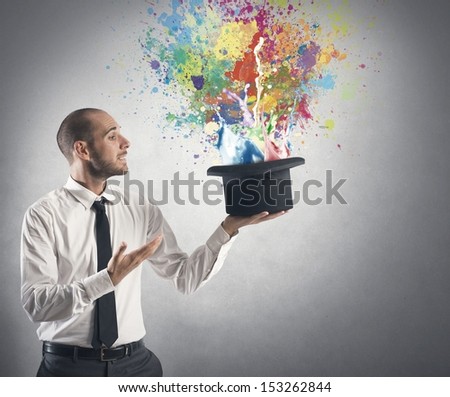 Businessman and creative idea concept with hat from which emerge the colors