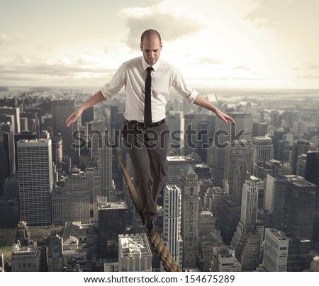 Concept of difficulty in business with equilibrist businessman