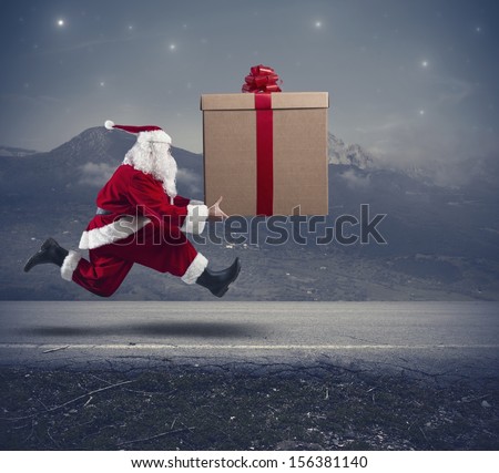 Running santa Claus with a big gift on a street
