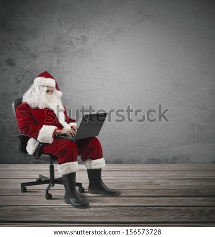 Concept of modern Santa Claus with laptop