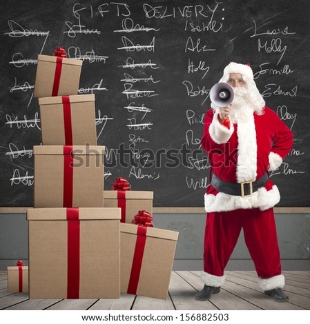 Santa Claus with megaphone with list of gifts delivery in a blackboard