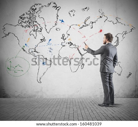 Global business concept with businessman that draws a world map