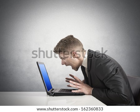 Businessman with blue screen showing laptop error