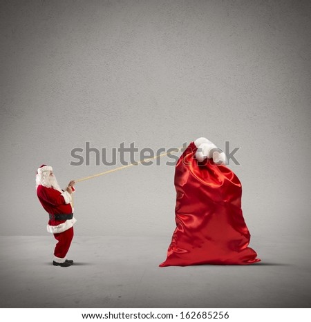 Santa claus pulls heavy bag of gifts