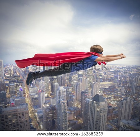 Superhero kid flying fast over the city