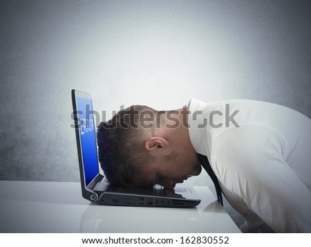 Businessman with blue screen of laptop error