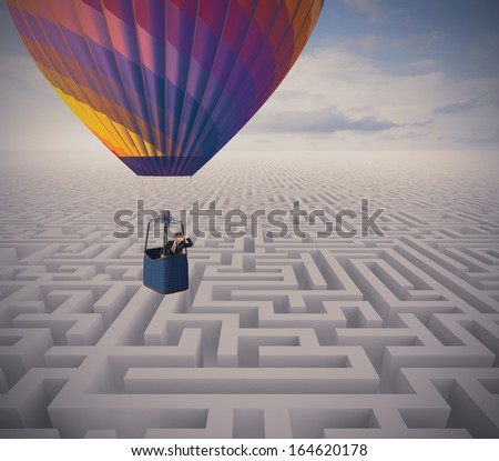 Concept of overcome obstacles with businessman on a hot air balloon