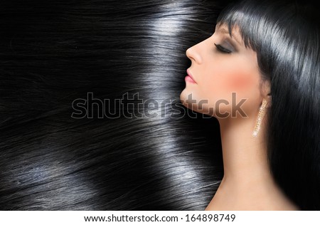 Beauty concept with log shiny hair of a beautiful brunette