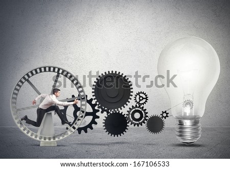 Businessman Powering An Idea With Gear System