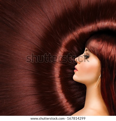 Long red  shiny hair of a beautiful young girl
