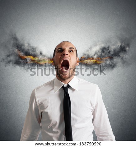 Stressed businessman with smoke and flame in head - stock photo
