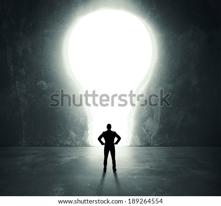 Businessman in front of a bright lightbulb door