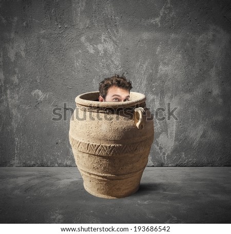 Concept of crisis with frightened businessman inside a vase