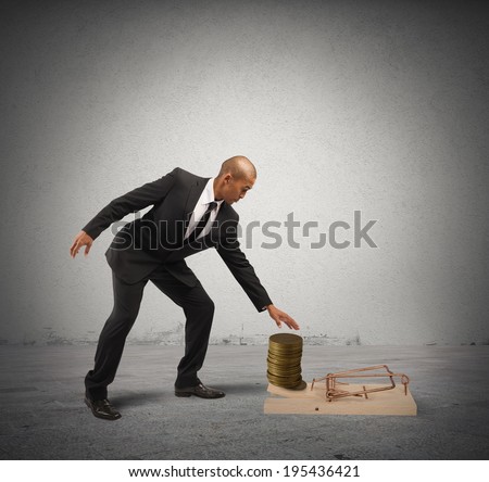 Concept of business trap with businessman taking money from a mousetrap