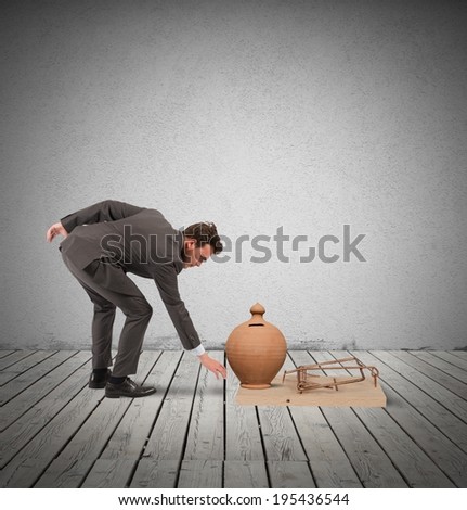 Concept of business trap with businessman taking money from a mousetrap