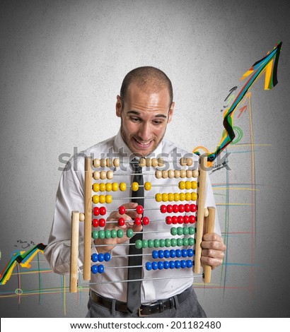 Businessman with abacus calculates a positive trend