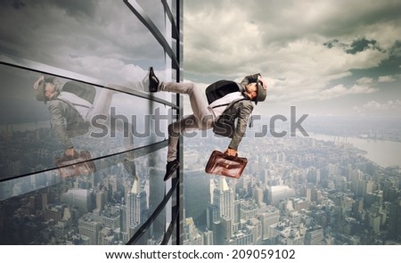 Determined man running up a skyscraper